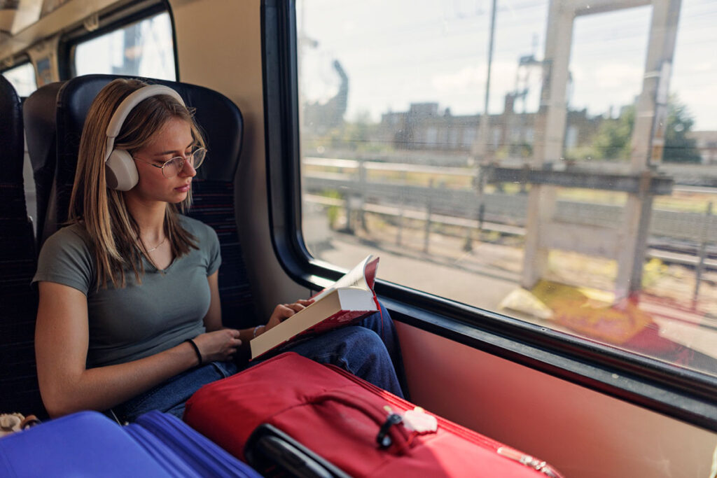 Woman reading book on train